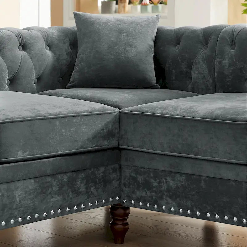 L-shaped sofa with deep-stitched details and curled armrests.