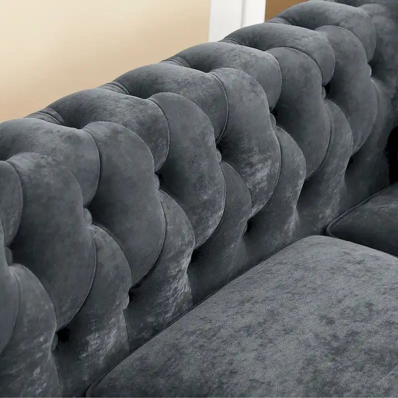 L-shaped sofa with deep-stitched details and curled armrests.